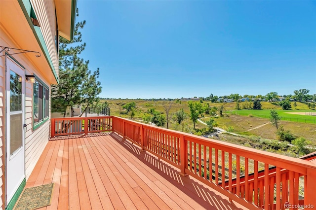 wooden terrace featuring a rural view