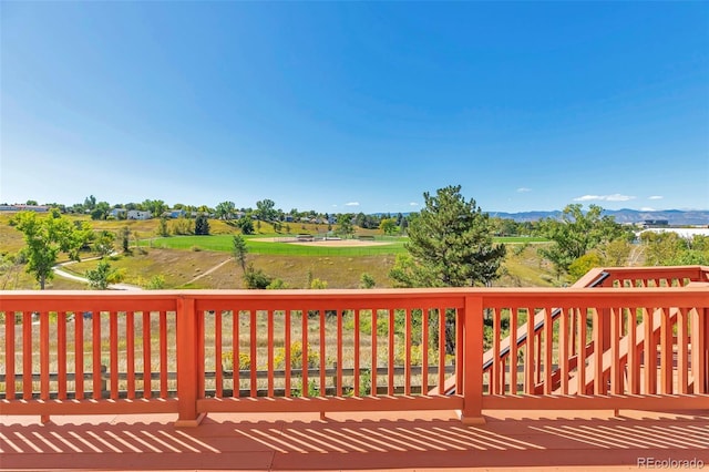 wooden terrace featuring a rural view