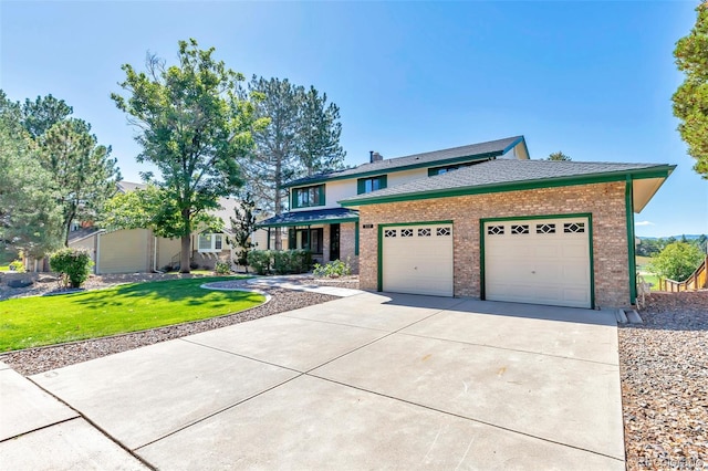 view of front of house with a garage and a front lawn