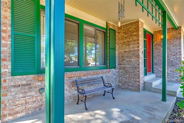 view of exterior entry with a porch