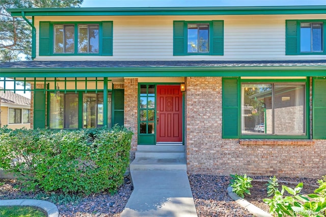 view of exterior entry with covered porch