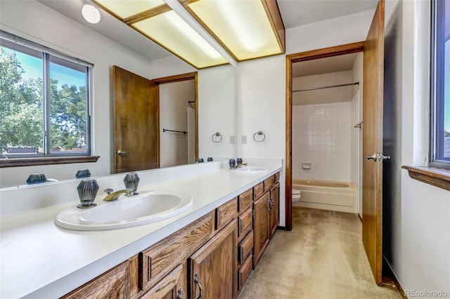 full bathroom featuring toilet, tiled shower / bath, and vanity