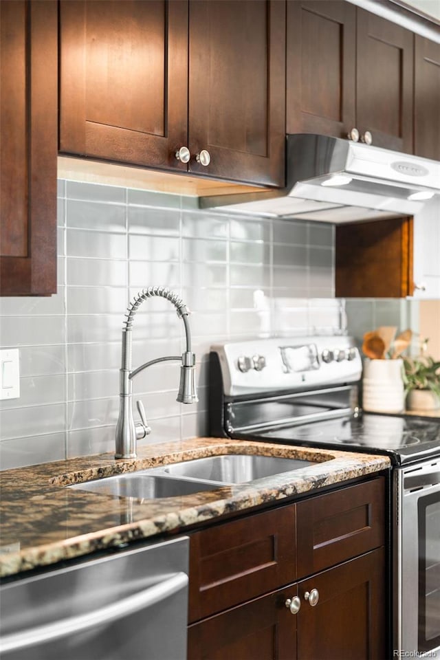 4300 Osage St, Denver, CO 80211 - kitchen with stainless steel appliances, backsplash, dark brown cabinetry, and dark stone counters