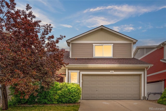 5536 Kirk St, Denver, CO 80249 - traditional-style house with driveway, a shingled roof, and an attached garage