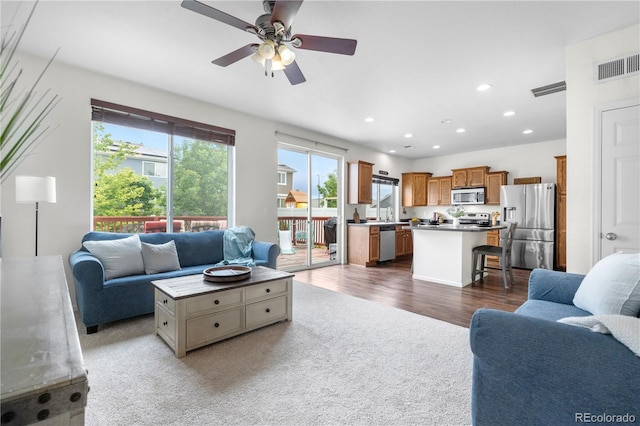 5536 Kirk St, Denver, CO 80249 - living area with ceiling fan, recessed lighting, wood finished floors, and carpet flooring