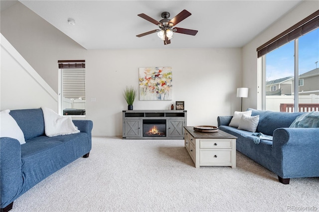 5536 Kirk St, Denver, CO 80249 - living area with light colored carpet, ceiling fan, and a glass covered fireplace