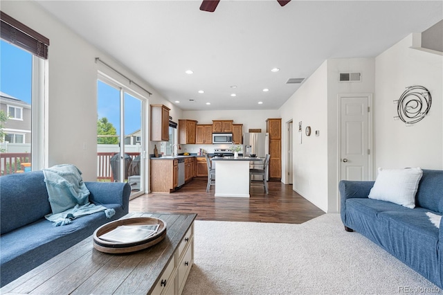 5536 Kirk St, Denver, CO 80249 - living room with dark colored carpet, ceiling fan, recessed lighting, and dark wood-style flooring