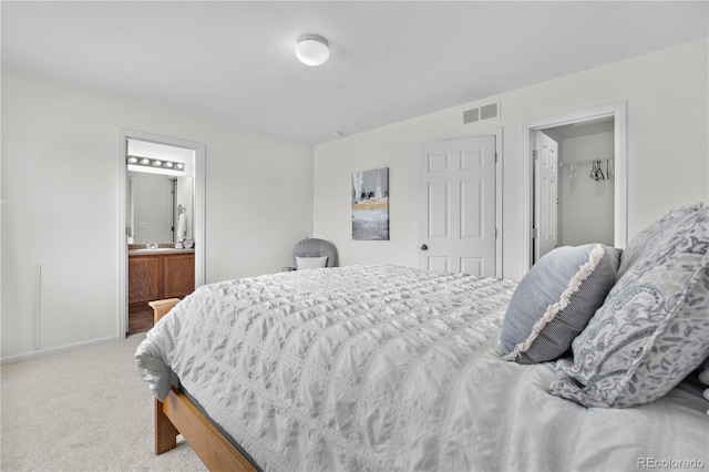 5536 Kirk St, Denver, CO 80249 - carpeted bedroom featuring baseboards, ensuite bathroom, a walk in closet, and a closet