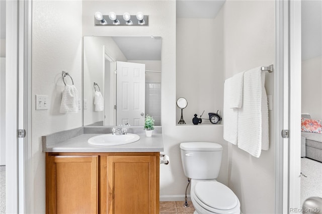 5536 Kirk St, Denver, CO 80249 - bathroom with vanity, toilet, tile patterned flooring, and baseboards