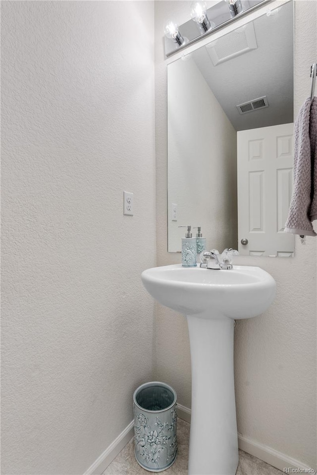5536 Kirk St, Denver, CO 80249 - bathroom with baseboards and a sink