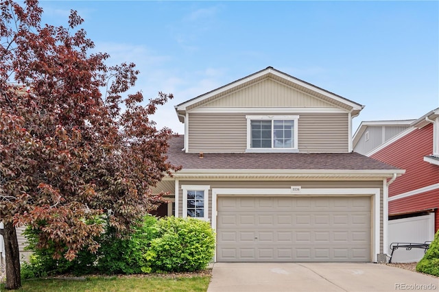 5536 Kirk St, Denver, CO 80249 - traditional-style house featuring driveway, an attached garage, and roof with shingles