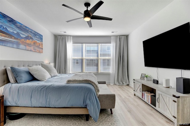 bedroom with ceiling fan and light hardwood / wood-style flooring