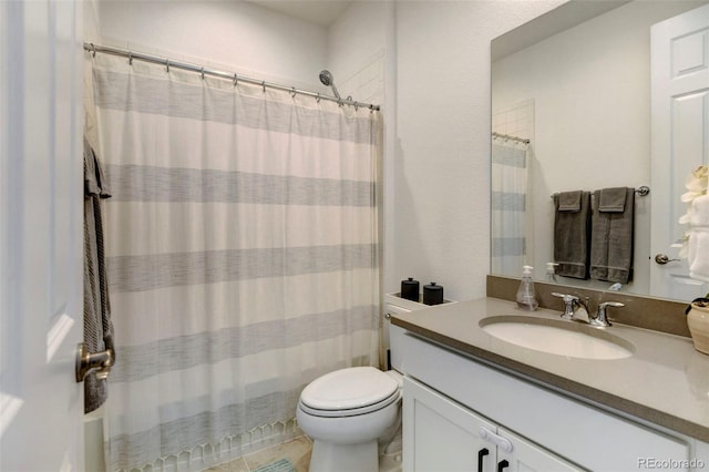 bathroom with vanity, toilet, and walk in shower