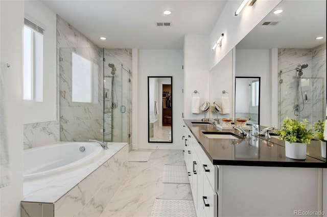 bathroom featuring vanity and shower with separate bathtub