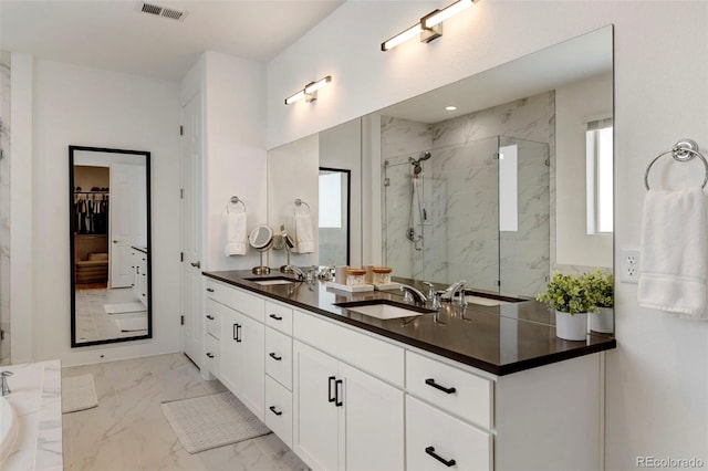 bathroom with vanity and a shower with door