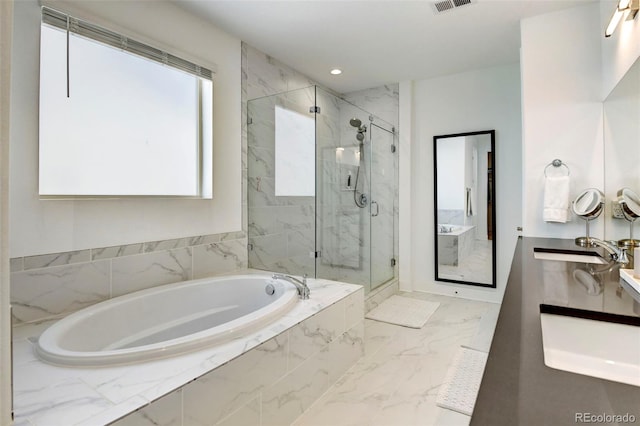 bathroom featuring vanity and separate shower and tub