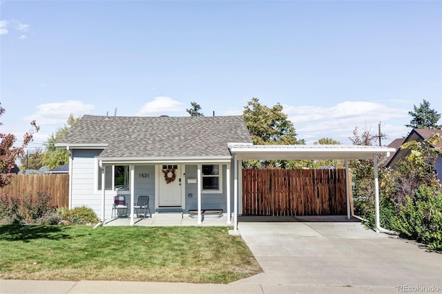 view of front of property with a front lawn, a carport, and covered porch