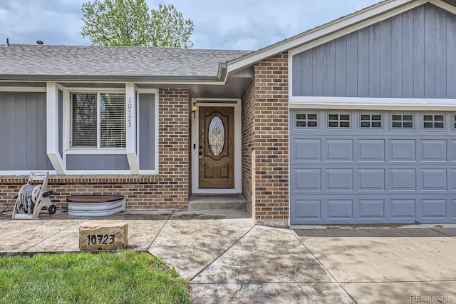 10723 Cherry Ct, Thornton, CO 80233 - property entrance with brick siding, an attached garage, and roof with shingles