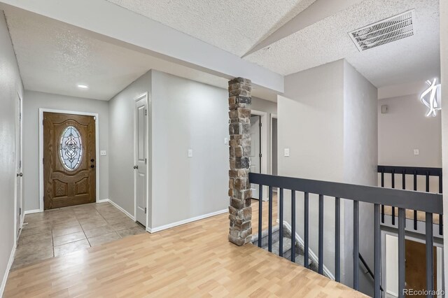 10723 Cherry Ct, Thornton, CO 80233 - entrance foyer with a textured ceiling, wood finished floors, and baseboards
