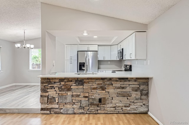 10723 Cherry Ct, Thornton, CO 80233 - kitchen featuring appliances with stainless steel finishes, light wood-style floors, white cabinets, baseboards, and a textured ceiling