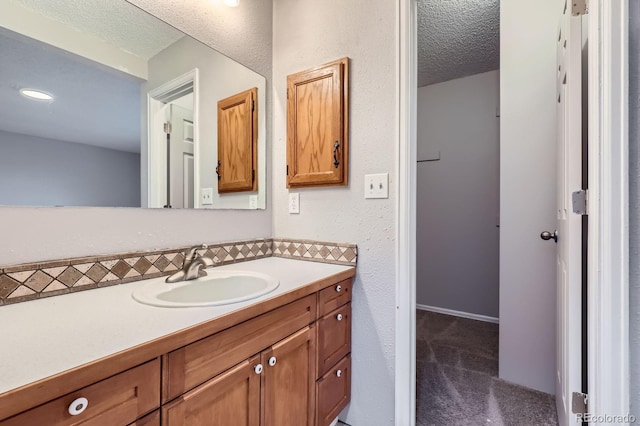 10723 Cherry Ct, Thornton, CO 80233 - bathroom featuring a textured ceiling and vanity