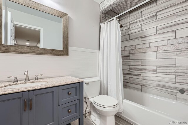 10723 Cherry Ct, Thornton, CO 80233 - full bath with toilet, vanity, shower / tub combo, and a wainscoted wall