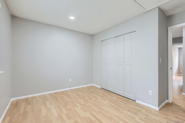 10723 Cherry Ct, Thornton, CO 80233 - unfurnished bedroom featuring light wood-style floors, baseboards, a closet, and recessed lighting