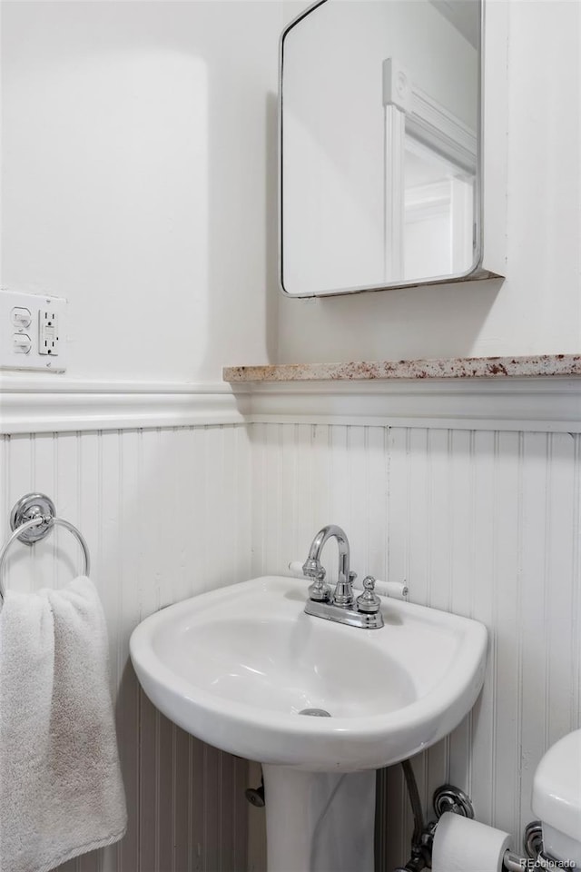 623 S Logan St, Denver, CO 80209 - half bath featuring a sink and wainscoting