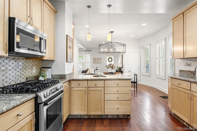 623 S Logan St, Denver, CO 80209 - kitchen with stainless steel appliances, light brown cabinets, a peninsula, plenty of natural light, and recessed lighting