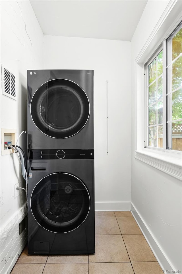 623 S Logan St, Denver, CO 80209 - washroom featuring stacked washer / drying machine and tile patterned floors