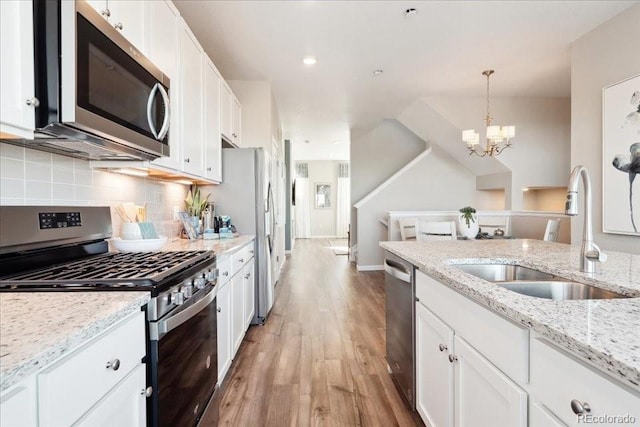 kitchen featuring a sink, white cabinets, and appliances with stainless steel finishes