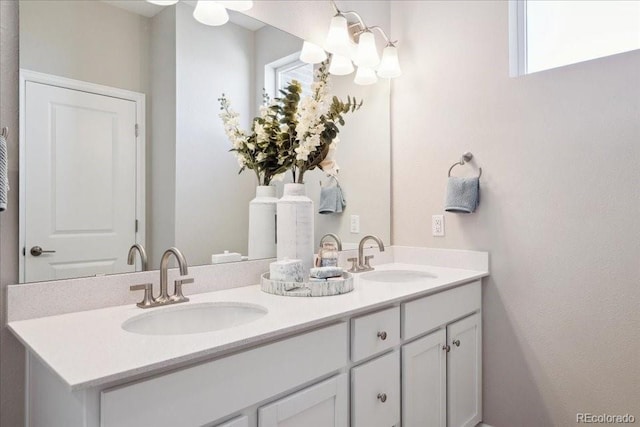bathroom with a sink and double vanity