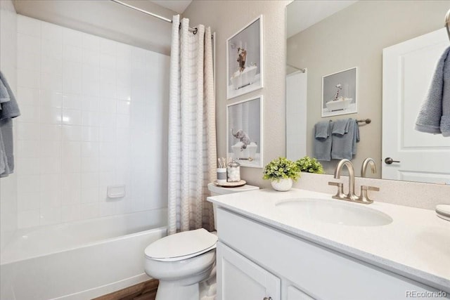 full bath featuring toilet, shower / bath combo, wood finished floors, and vanity