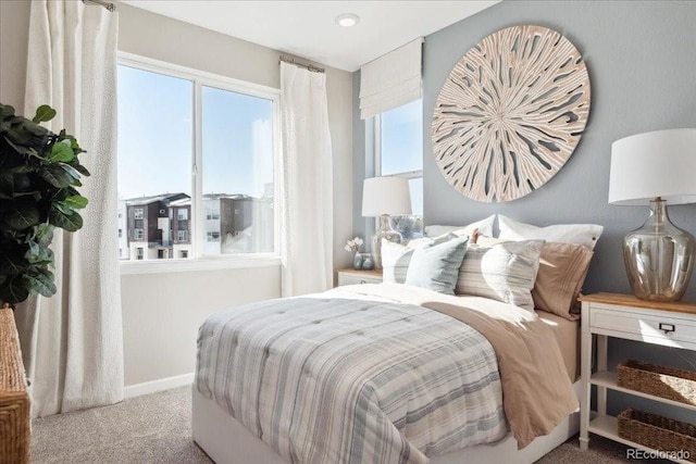 carpeted bedroom featuring baseboards