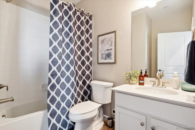 bathroom featuring a textured wall, toilet, vanity, and shower / bathtub combination with curtain