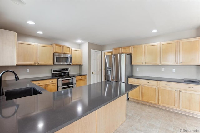 4016 S Rome St, Aurora, CO 80018 - kitchen featuring stainless steel appliances, light brown cabinetry, a sink, dark countertops, and recessed lighting