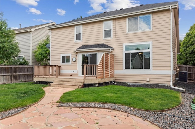 4016 S Rome St, Aurora, CO 80018 - back of property with a wooden deck, central air condition unit, and a patio area