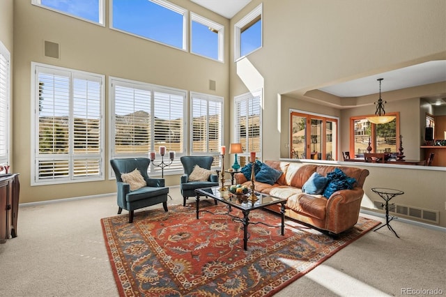 carpeted living room with a wealth of natural light and visible vents