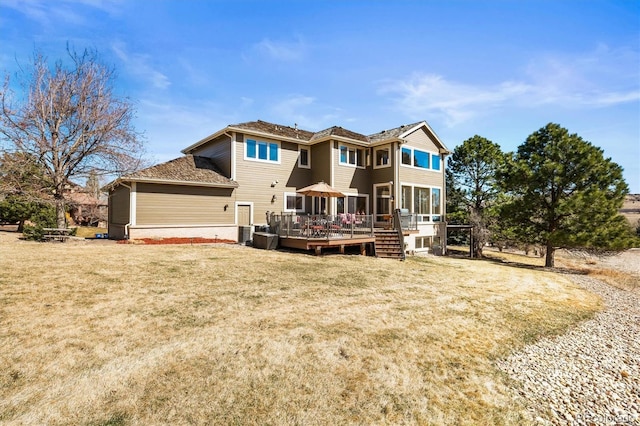 rear view of house featuring a yard, central AC unit, and a wooden deck