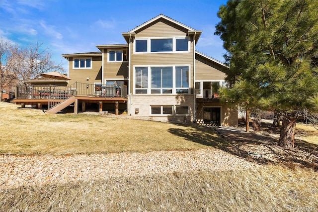 rear view of property featuring a yard and a wooden deck