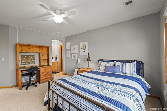 bedroom with arched walkways, visible vents, light carpet, ceiling fan, and baseboards