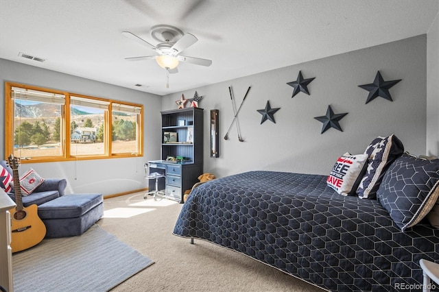 carpeted bedroom with a ceiling fan, visible vents, and baseboards