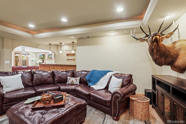 living room featuring arched walkways, a tray ceiling, recessed lighting, pool table, and visible vents