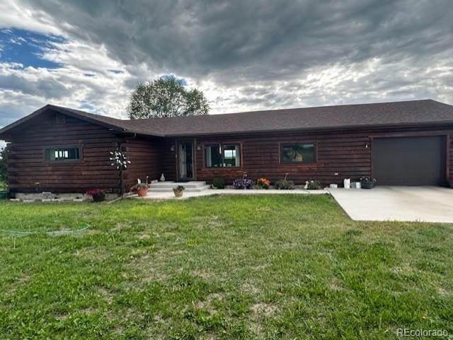 log-style house featuring a front yard and a garage