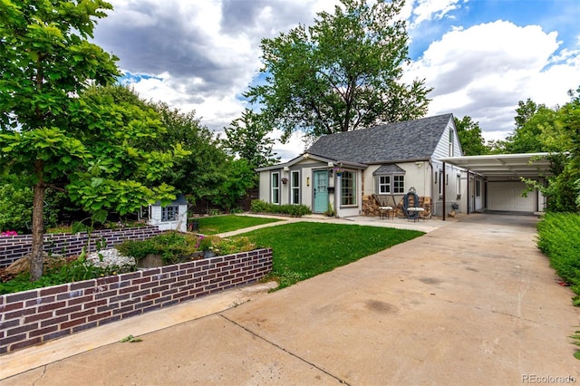 1946 Xenia St, Denver, CO 80220 - view of front of property with a carport, a front yard, concrete driveway, stucco siding, and roof with shingles