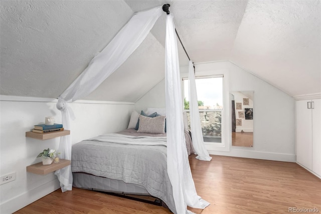 1946 Xenia St, Denver, CO 80220 - bedroom with a textured ceiling, wood finished floors, and lofted ceiling