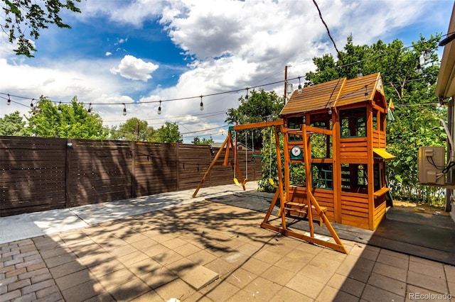 1946 Xenia St, Denver, CO 80220 - fenced backyard with a playground and a patio area