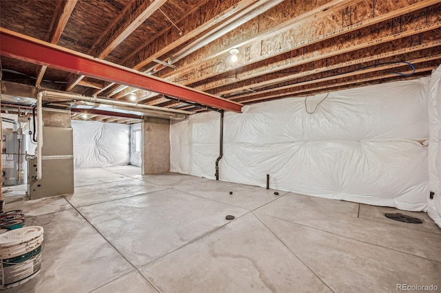 basement featuring heating unit and gas water heater