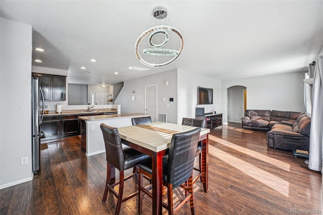 dining area featuring sink and dark hardwood / wood-style floors