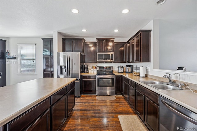 kitchen with dark hardwood / wood-style flooring, sink, dark brown cabinetry, and stainless steel appliances